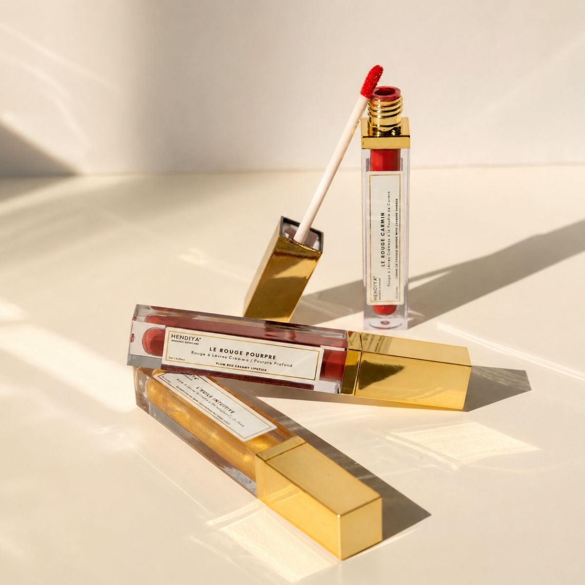 Range of tinted lip skincare by Hendiya, including L'Huile Intuitive